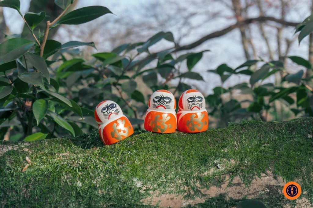 Daruma Dolls in Lush Nature Setting, Osaka