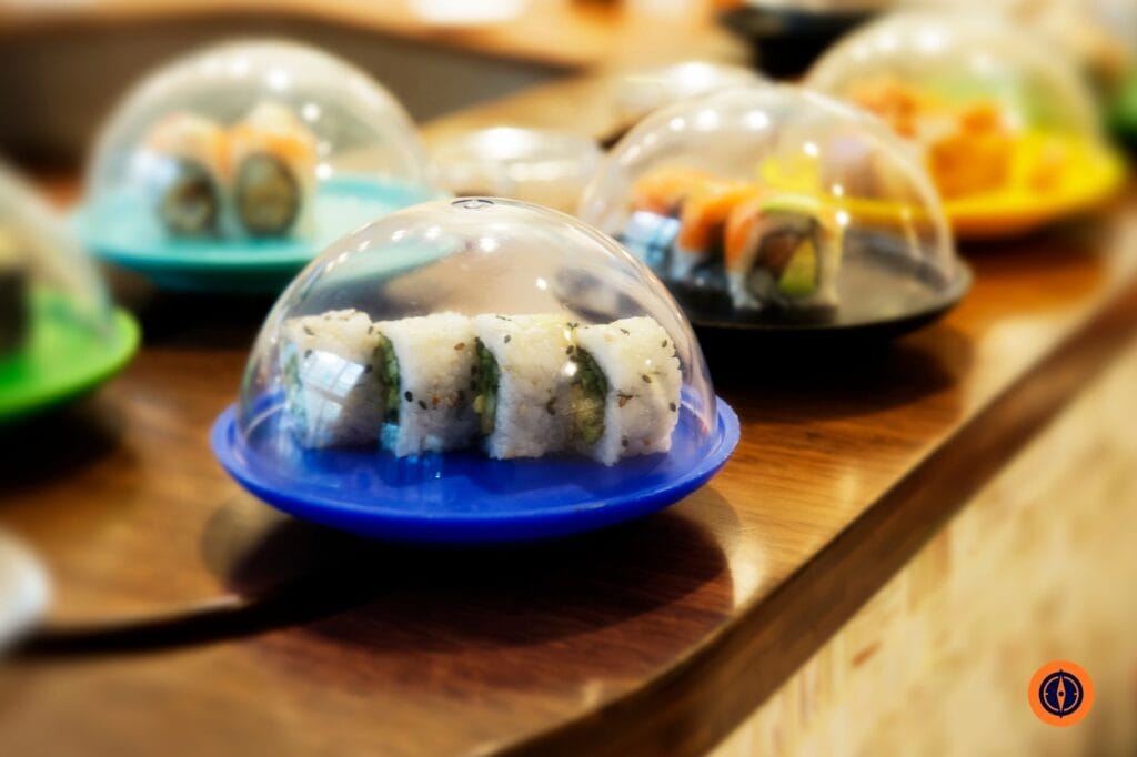 Sushi on colored plates conveyor belt