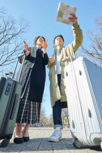 Traveling Couple Checking Map with Luggage
